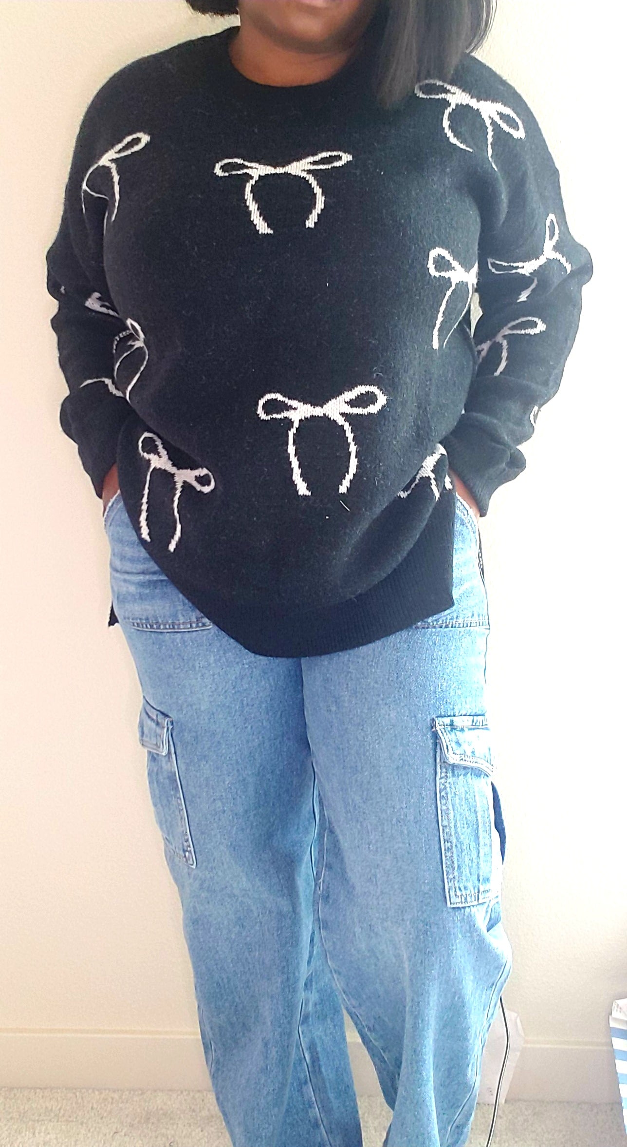 Black sweater with white bow design