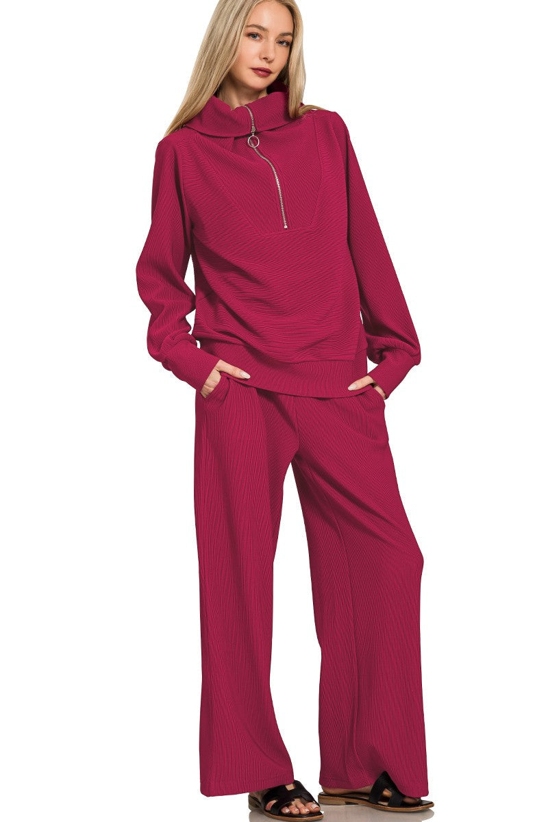 Woman wearing a cabernet-colored outfit on a white background